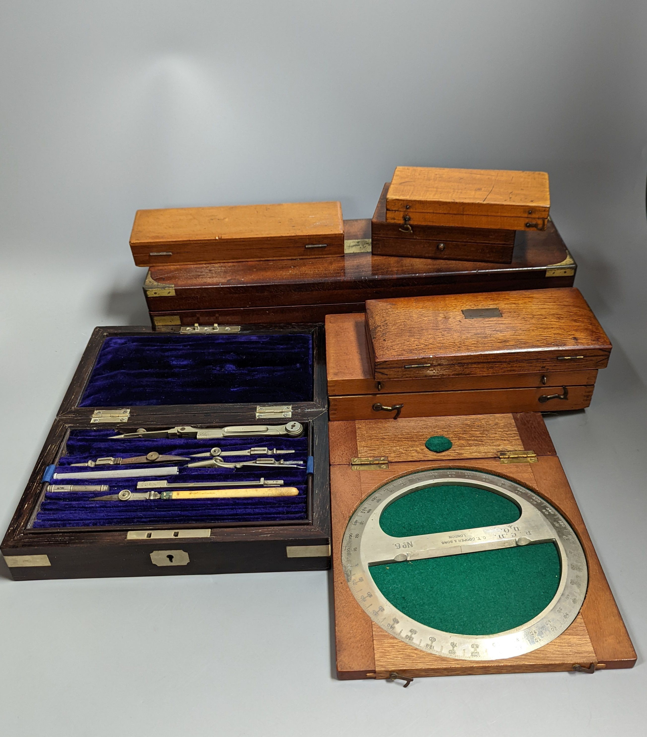 A collection of mahogany cased drawing instruments (8)